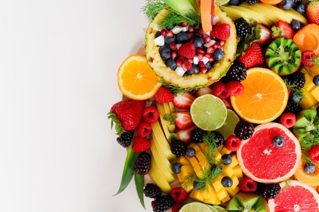 pexels photo 1128678 Colorful flat lay of assorted tropical fruits including pineapple, berries, and citrus.