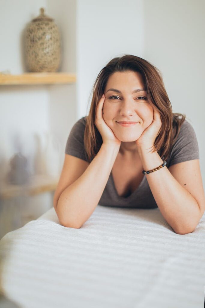 pexels photo 3865664 Woman smiling indoors, enjoying a relaxing spa day with a happy expression.